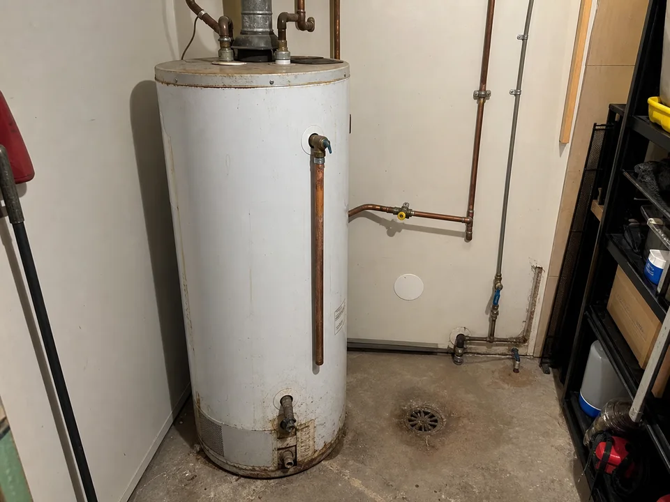 The aging water heater before replacement.